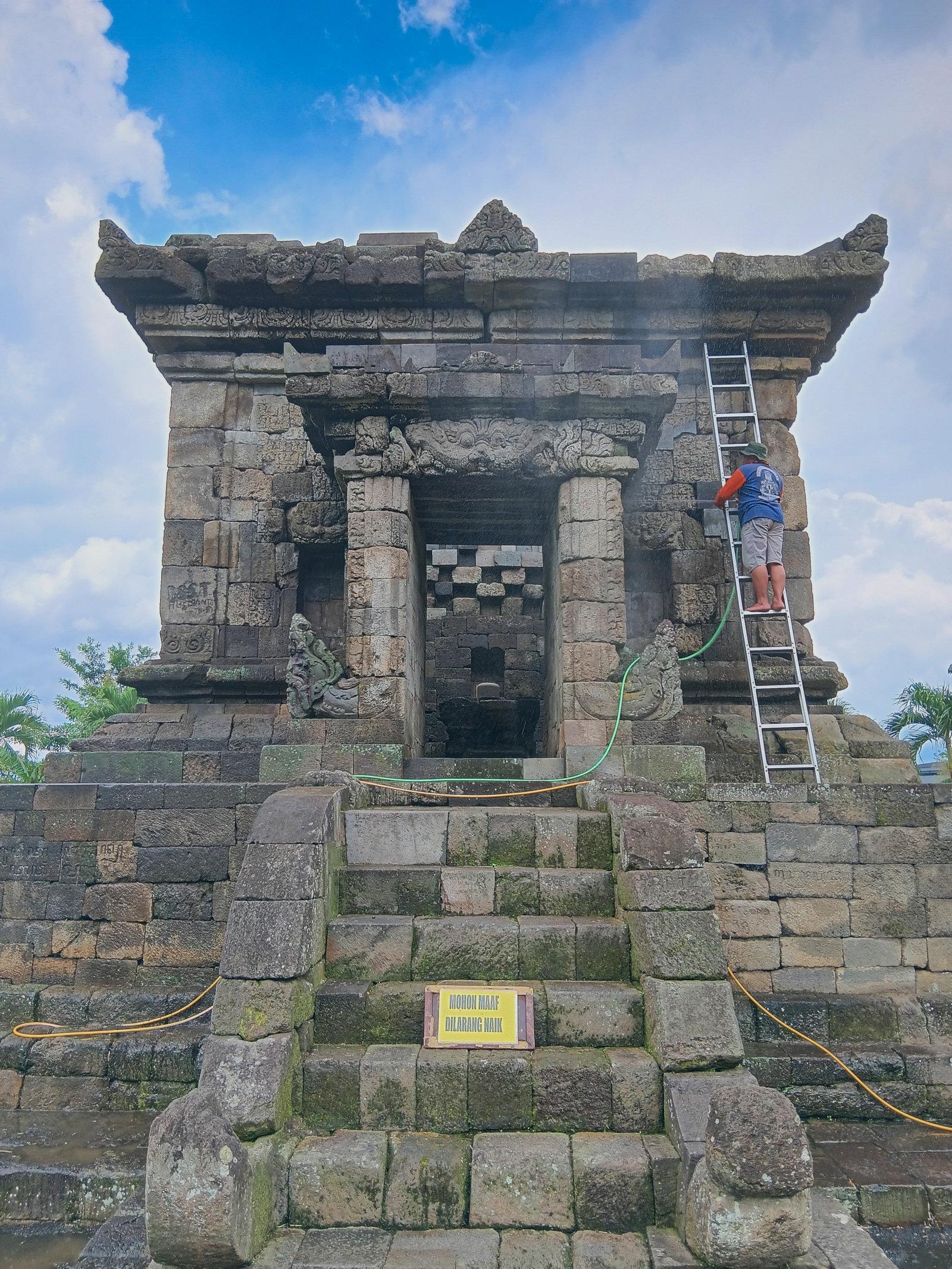 The gate to the inner chamber. The building is being washed so the entrance is closed. A lingga and yoni sculpture can be seen inside.