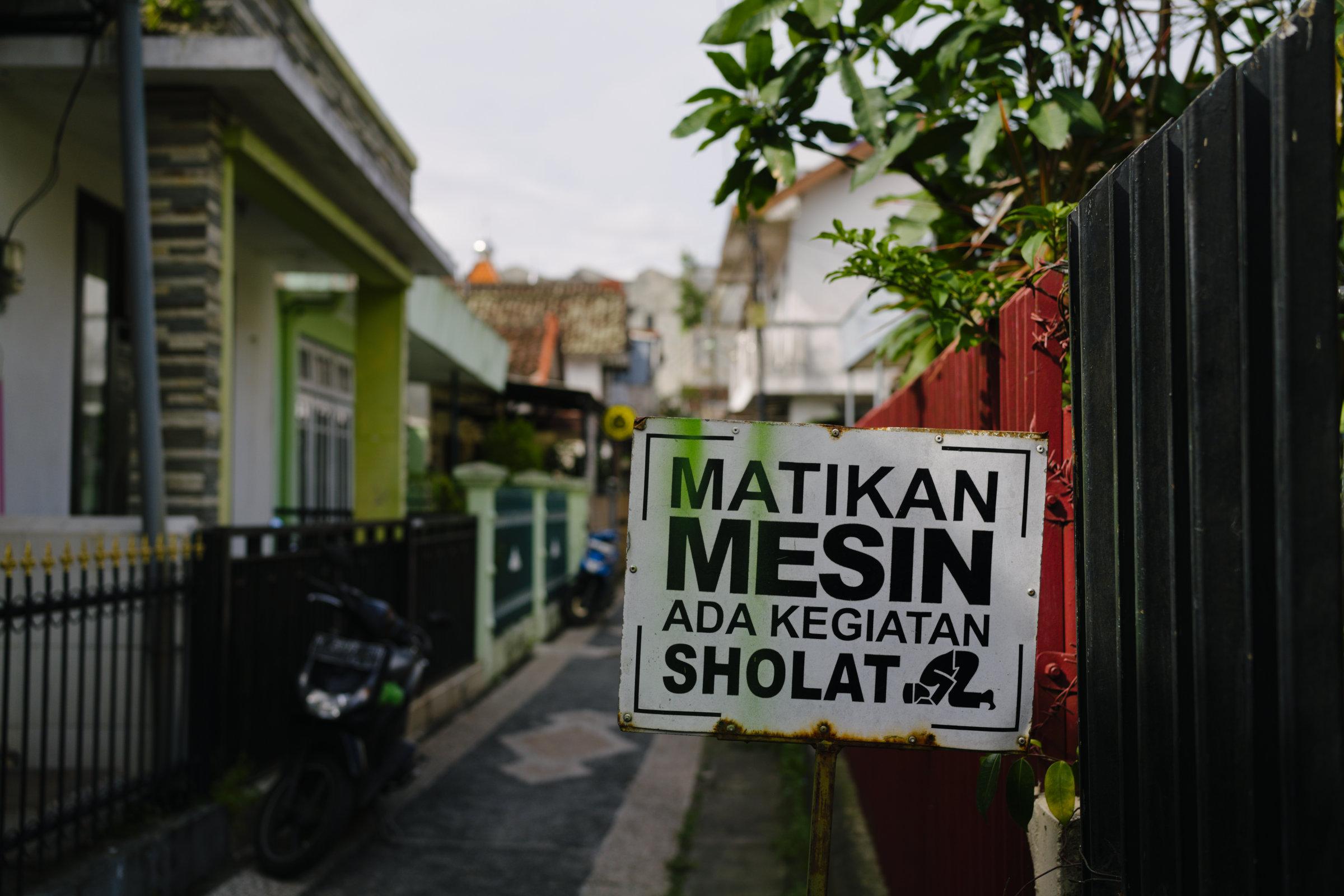 In front of a mosque in the area. There's a signpost reading "matikan mesin, ada kegiatan sholat" ("turn off your (motor vehicle's) engine, prayer session ongoing").